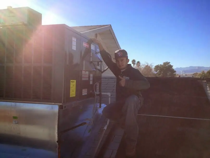 HVAC technician performing Air Duct Repair on a rooftop unit in North Lynnwood